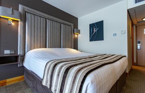a bedroom with a large bed in a room at The Big Blue Hotel - Blackpool Pleasure Beach in Blackpool