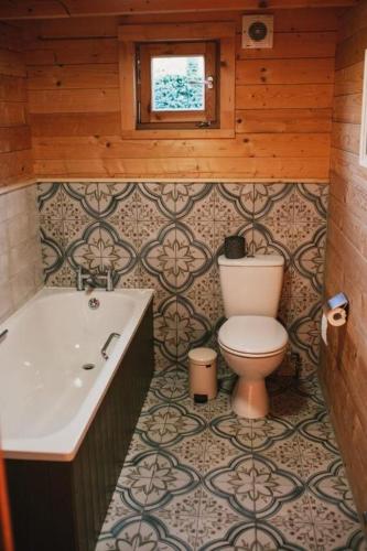 a bathroom with a toilet and a sink at Wood Cabin 2 At Tapnell Farm in Yarmouth