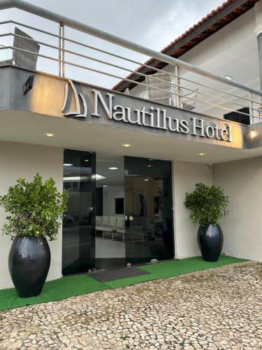 two large vases sitting in front of a hotel at Nautillus Hotel in Parnaíba