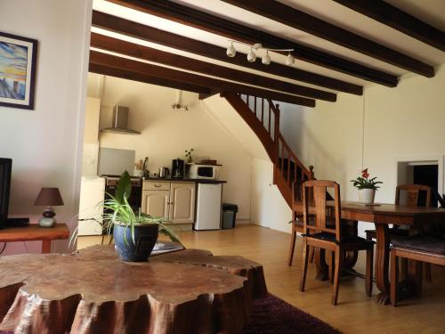 un salon avec une table et une cuisine dans l'établissement Gîte nature à La Chapelle de Brain, à La Chapelle-de-Brain