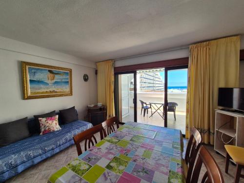 a living room with a table and a couch at Parque Royale 1 apartment with an amazing ocean view in Adeje