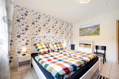 a bedroom with a bed with a colorful blanket at Rheinferien in Kamp-Bornhofen