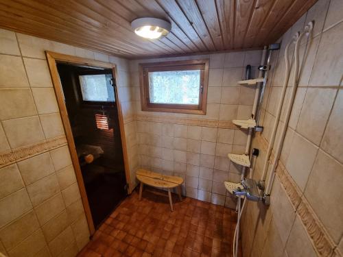 a small bathroom with a door and a window at Villa Anna in Rauma