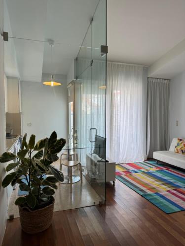 a living room with a glass table and a couch at Apartment in Santos in Lisbon