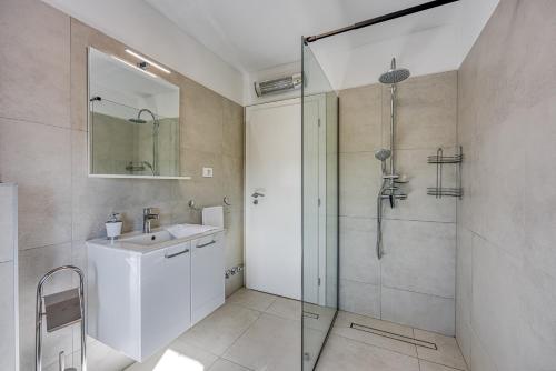 a bathroom with a glass shower and a sink at Ferienlandhaus Zvanya in Kozljak