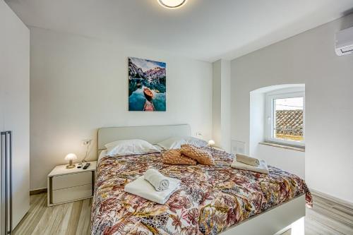 a white bedroom with a bed and a desk at Ferienlandhaus Zvanya in Kozljak