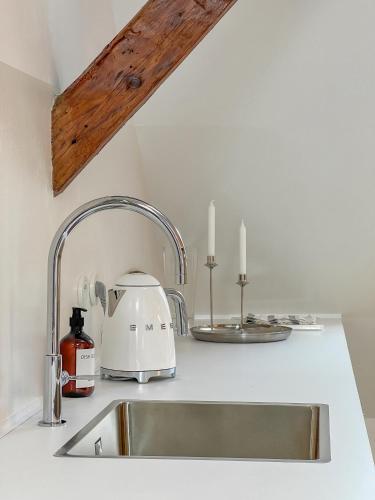 a kitchen counter with a sink and a toaster and candles at CASAROSA Attico apt 3BR, 3BA in Český Krumlov