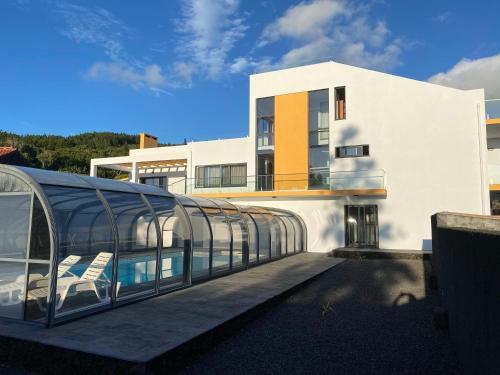 a building with a glass walkway in front of it at Villa MarAzul in Horta