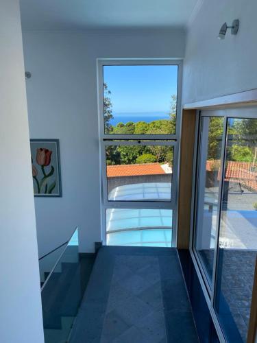 a room with a window and a view of the ocean at Villa MarAzul in Horta