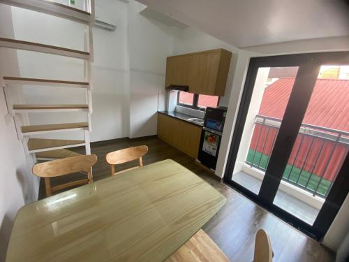 a kitchen with a table and two chairs and a window at Era Apartment Khuc Thua Du in Hanoi