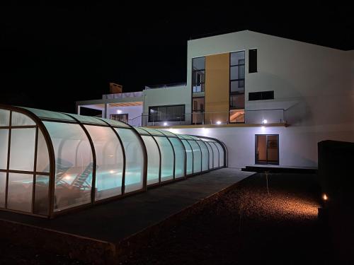 a building with a glass roof at night at Villa MarAzul in Horta