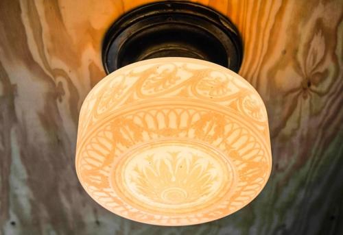 a light on a wooden door with a design on it at Indigo Pass Boutique Hotel in Middletown