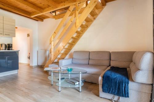 a living room with a couch and a table at Stofnerhof Alpenherz in Sarntal