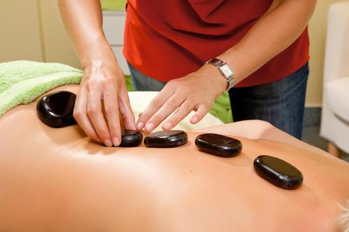 a person is arranging rocks on top of a pillow at Parkhotel Rügen in Bergen auf Rügen