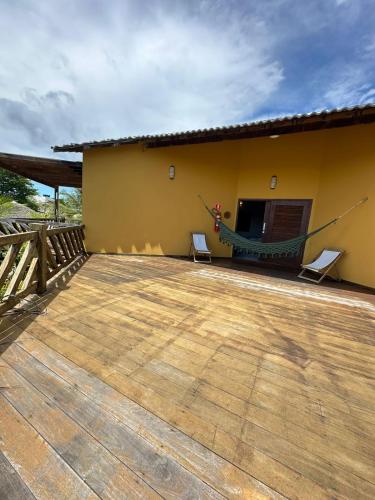 a porch of a house with a hammock on it at Pousada Vento do Kite in Barra Grande