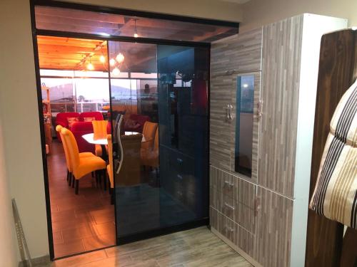 a room with a glass partition with a table and chairs at The Big blue house in Chimbote