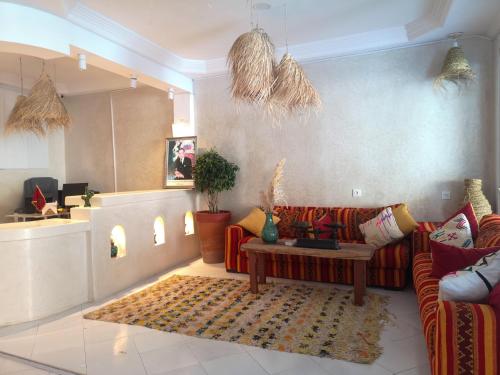 a living room with a couch and a table at Locals Taghazout surfcamp in Taghazout