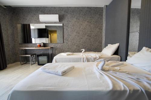 Postel nebo postele na pokoji v ubytování Emilia Otel