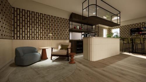 a living room with two chairs and a table at Strandhotel de Logerij in Renesse