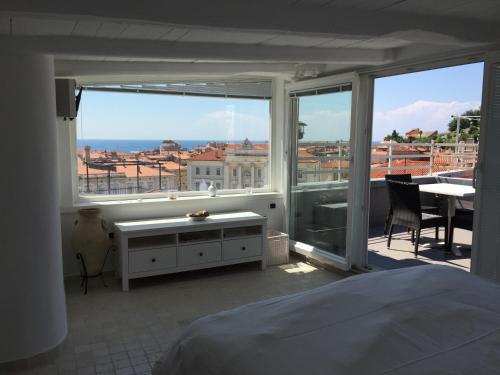 a bedroom with a bed and a view of the ocean at Apartment Sebastijan in Piran