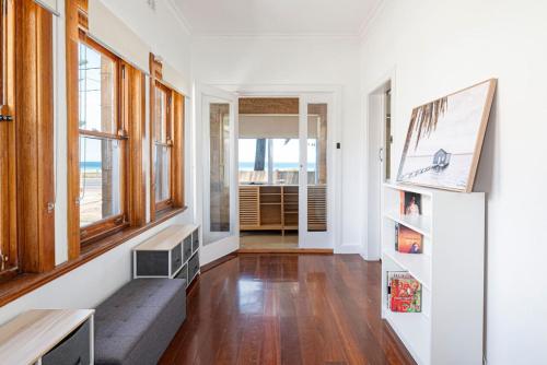 a living room with a couch and windows at Serenity by the Sea - 4BR Home with beach views in Largs