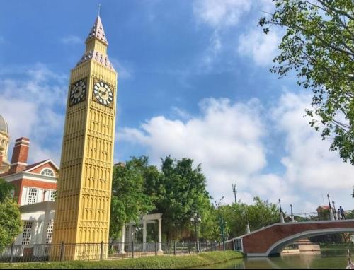 a large clock tower in front of a building at AMI POLARIS 23 Apartment-Residence in Phnom Penh