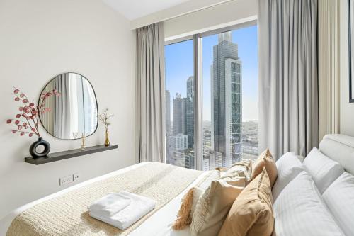 a bedroom with a bed and a large window at Silkhaus Chic 1 BDR In a New Tower In Downtown in Dubai