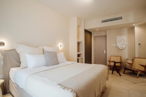 a bedroom with a large white bed in a room at Thymises Boutique Hotel in Kakopetria