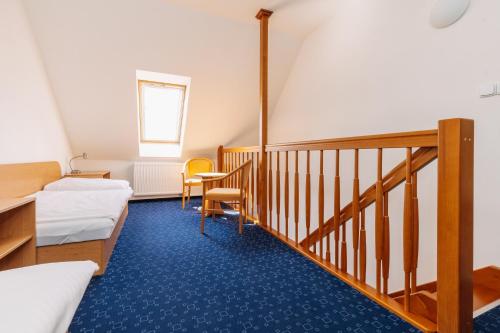 a room with two beds and a staircase at Apartmány Engadin in Boží Dar