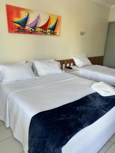 two beds sitting next to each other in a room at Nautillus Hotel in Parnaíba