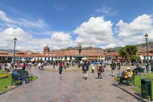 a group of people walking around a town square at Casa Muru By Wynwood House in Cusco