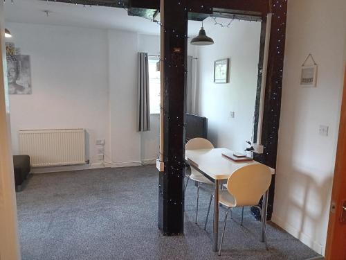 a dining room with a table and chairs in a room at Apartment in Historic Mill, near Dover Port in Kent