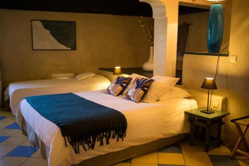 a hotel room with two beds in a room at In Provence Hôtel - Expérience Authentique in Venelles