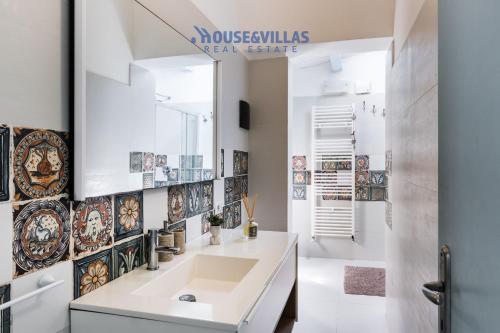 a bathroom with a sink and a mirror at House&Villas - Villa Karibu in Marina dʼAvola