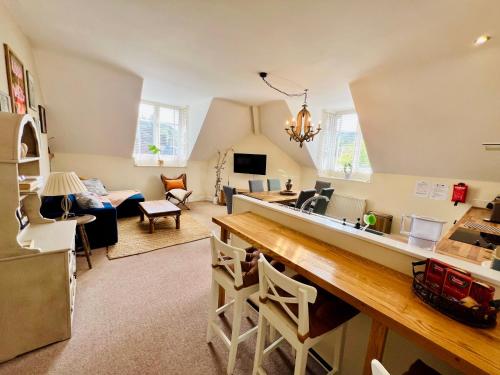 a kitchen and living room with a large counter top at Top floor double en-suite BR apartment central Matlock in Matlock