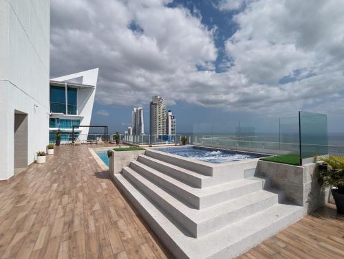 a swimming pool on the roof of a building with stairs at Fantastic 2BR with balcony in Costa del Este in Panama City