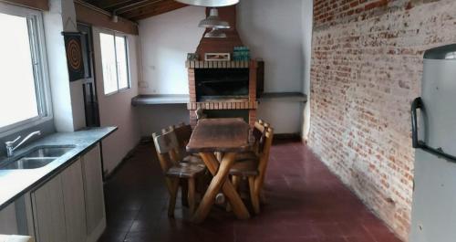 a kitchen with a table and chairs in a room at Hostel Ohana in Mar del Plata
