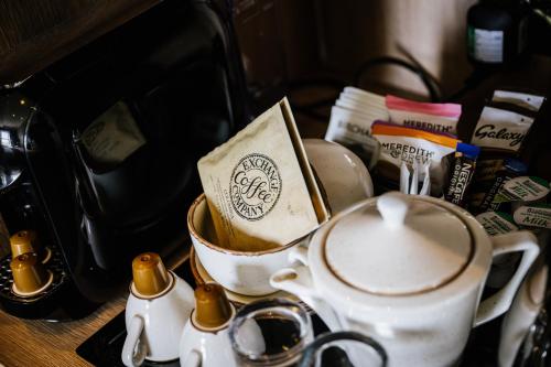a tea pot and cups on a table at Clifton Arms Hotel in Lytham St Annes