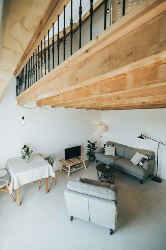 a living room with a staircase and a couch at Gastenverblijven boerderij Het Driespan in Middelburg