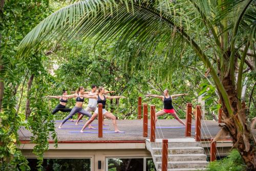a group of women doing yoga on a bridge at BodyHoliday St Lucia in Gros Islet