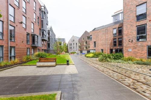 a park with a bench and some buildings at For Students Only Student Roost Tramways Chester in Chester