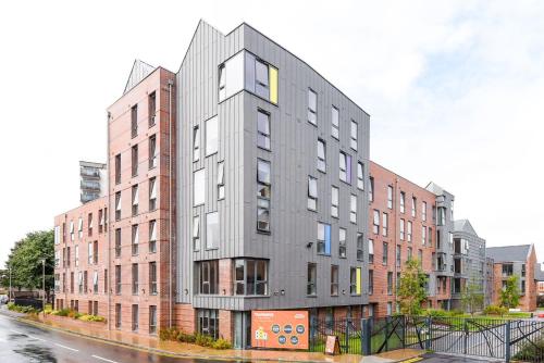 a tall gray building on a city street at For Students Only Student Roost Tramways Chester in Chester