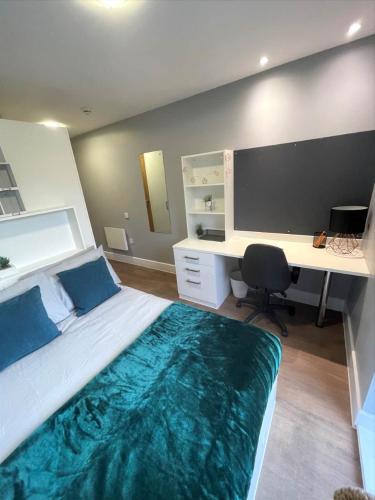 a bedroom with a bed with a desk and a computer at For Students Only Student Roost Tramways Chester in Chester