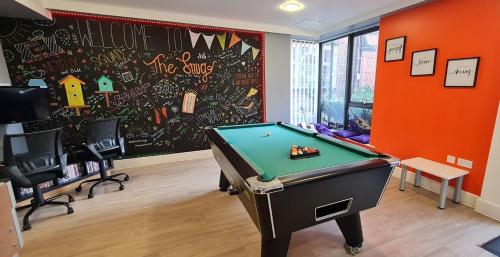 a room with a pool table in front of a wall at For Students Only Student Roost Tramways Chester in Chester
