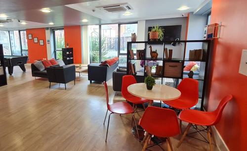 a living room with red chairs and a table at For Students Only Student Roost Tramways Chester in Chester