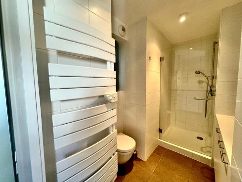un baño con inodoro y ducha en «  Le Sand-Wedge » appartement vue mer, en Wimereux