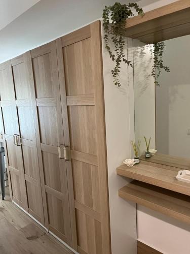 a closet with wooden doors in a room at GARDEN HOUSE Madrid in Madrid