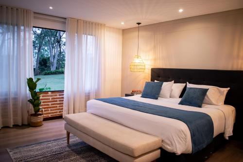 a bedroom with a large bed and a window at Monarch Campestre- Rionegro in Rionegro
