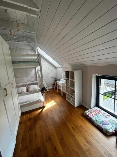 an attic room with two bunk beds and a desk at VILLA KATARINA with heated pool in Liptovský Mikuláš
