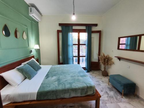 a bedroom with a large bed and a window at Electra's Seaside in Agios Georgios